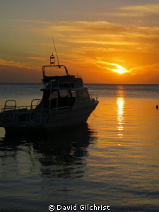 Sunset,West End, Roatan Honduras with  Native Sons Dive b... by David Gilchrist 